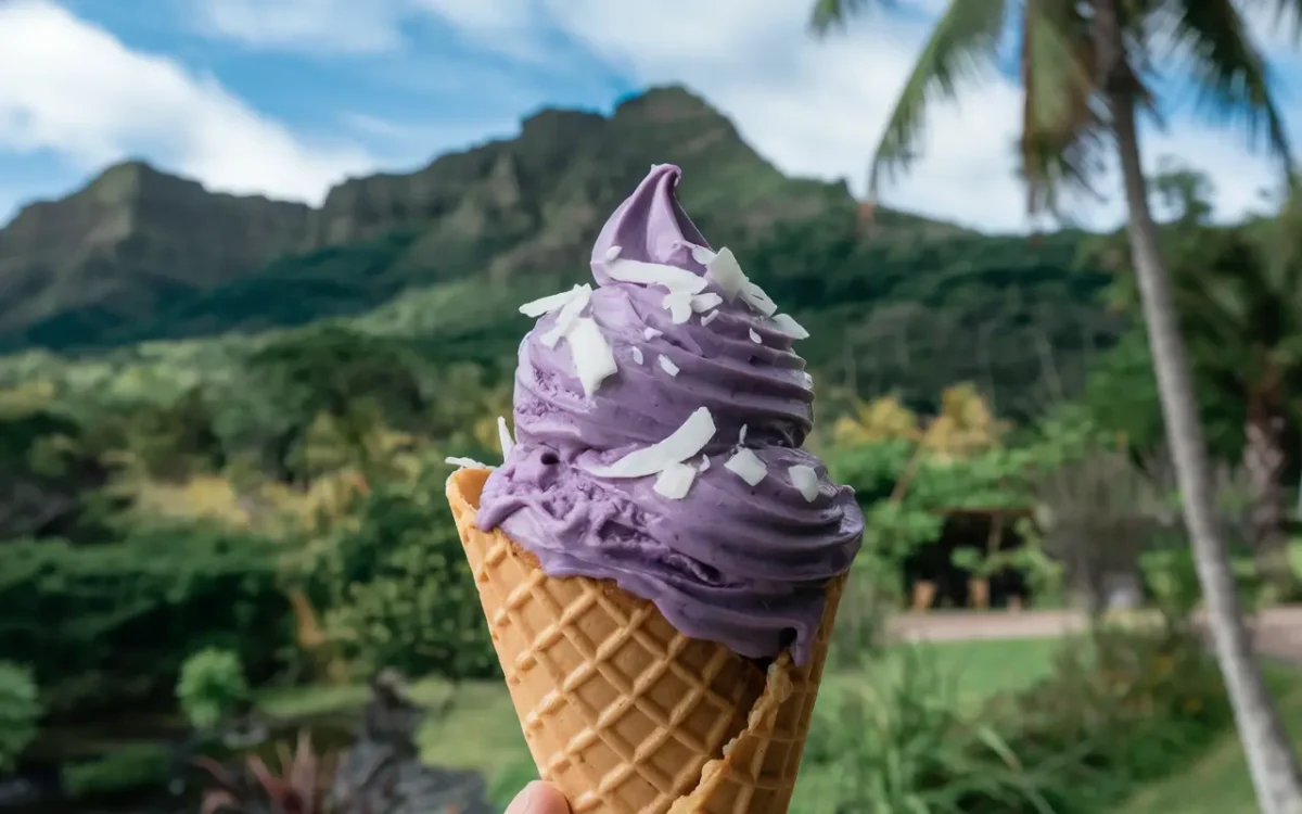 Scoop of ube ice cream in cone with tropical background