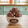 A bowl of moose tracks ice cream with fudge and peanut butter cups