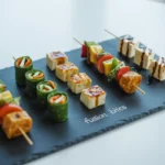 Fusion bites and plant-based skewers on slate platter