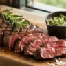 Grilled sirloin cap steak on a wooden board