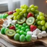 Grinch charcuterie board with green snacks and festive holiday colors