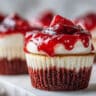 Strawberry cheesecake red velvet cupcakes with creamy center and strawberry topping